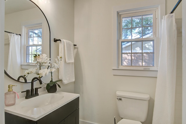 bathroom featuring toilet and vanity