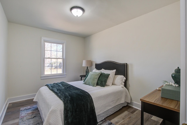 bedroom featuring baseboards and wood finished floors