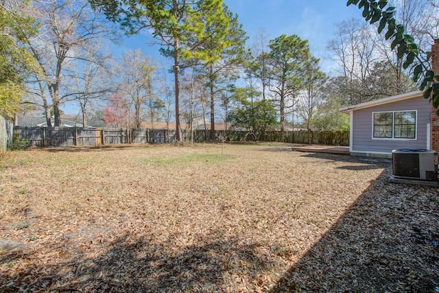 view of yard with central AC unit and fence