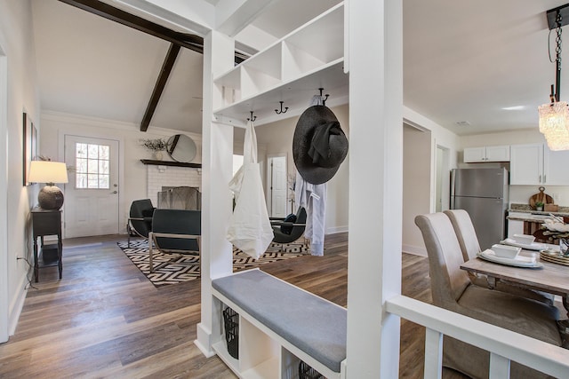 mudroom featuring a fireplace, beamed ceiling, baseboards, and wood finished floors