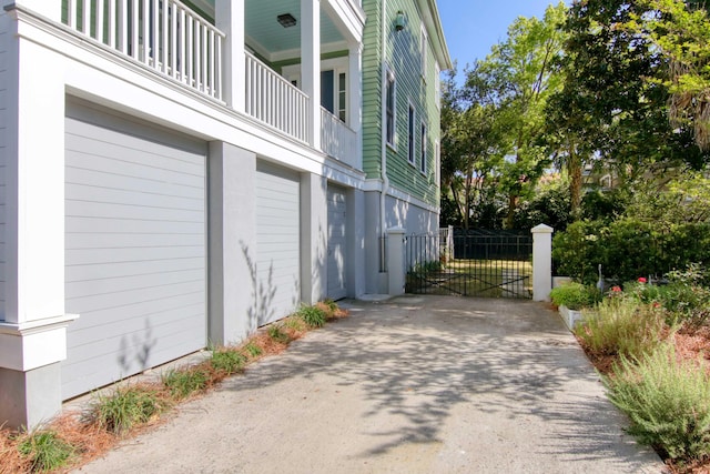 view of side of property featuring a garage and a balcony