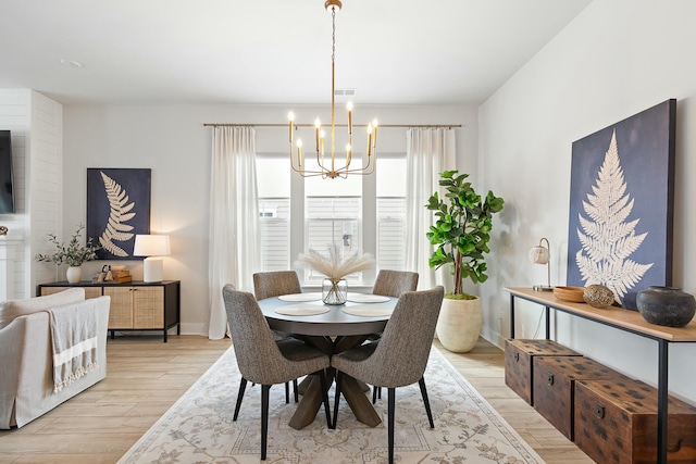 dining room featuring an inviting chandelier and light wood-type flooring