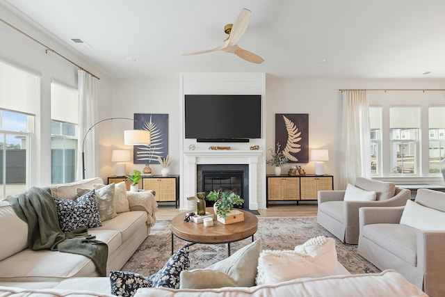 living room featuring ceiling fan and light wood-type flooring