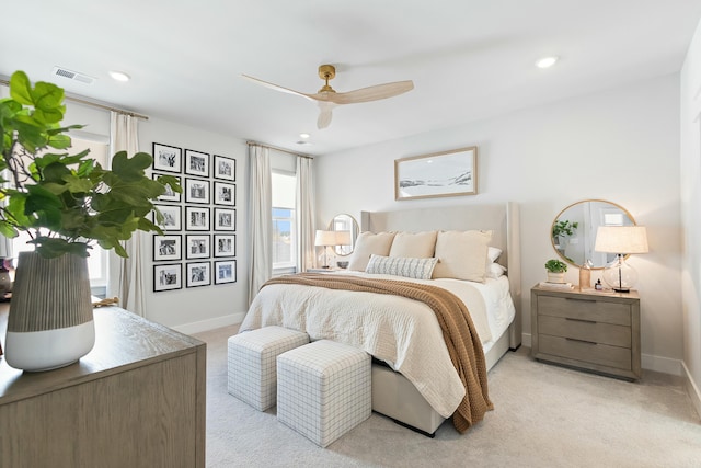 carpeted bedroom with multiple windows and ceiling fan