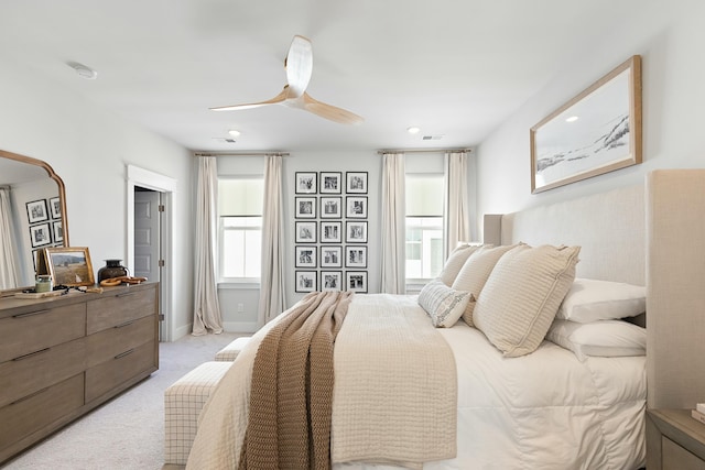 bedroom featuring light carpet and ceiling fan