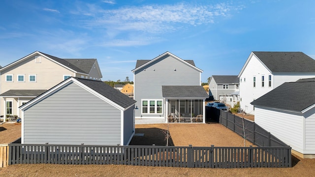 rear view of property with a sunroom