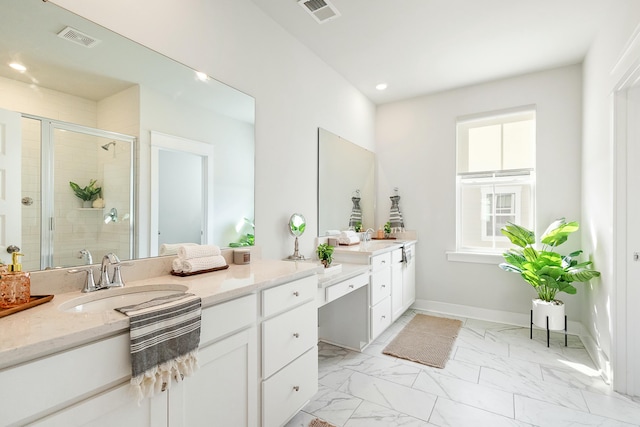 bathroom featuring vanity and a shower with shower door