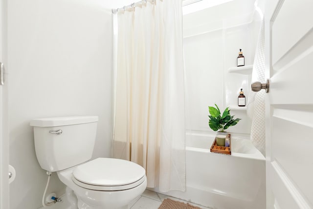 bathroom featuring toilet, tile patterned flooring, and shower / tub combo