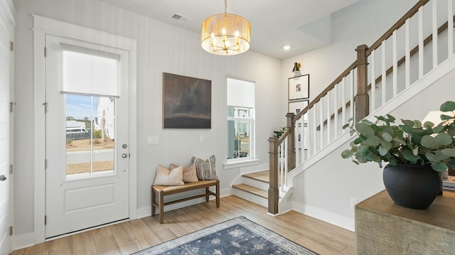 foyer featuring an inviting chandelier and light wood-type flooring