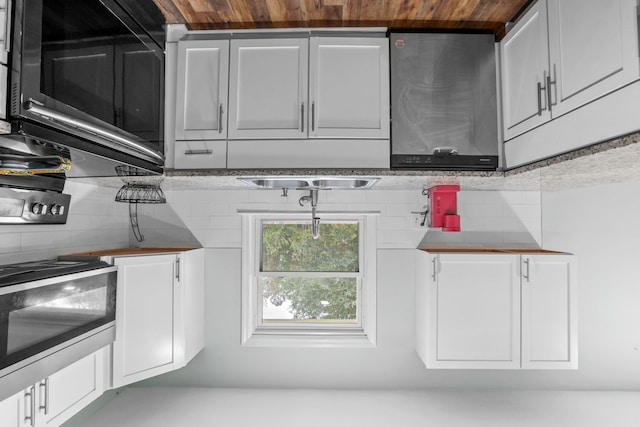 kitchen with tasteful backsplash and white cabinetry