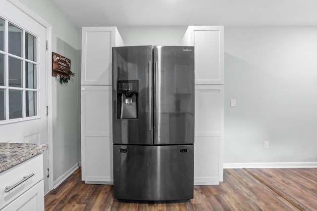 kitchen with white cabinetry, stainless steel fridge with ice dispenser, light stone countertops, and dark hardwood / wood-style floors