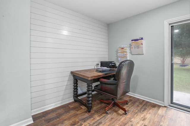 office space featuring dark hardwood / wood-style floors and wood walls