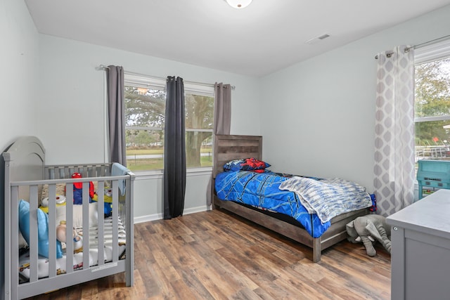 bedroom with hardwood / wood-style floors