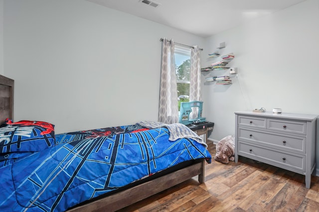 bedroom with dark wood-type flooring