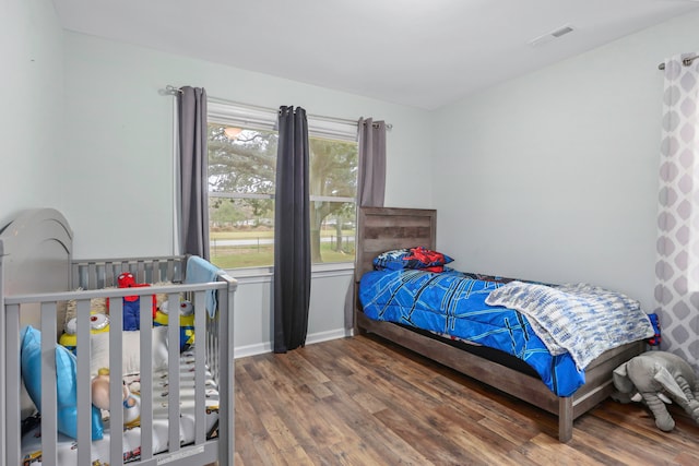 bedroom with hardwood / wood-style flooring