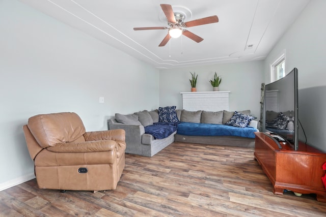 living room featuring hardwood / wood-style floors and ceiling fan