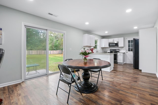 dining space featuring dark hardwood / wood-style floors and sink