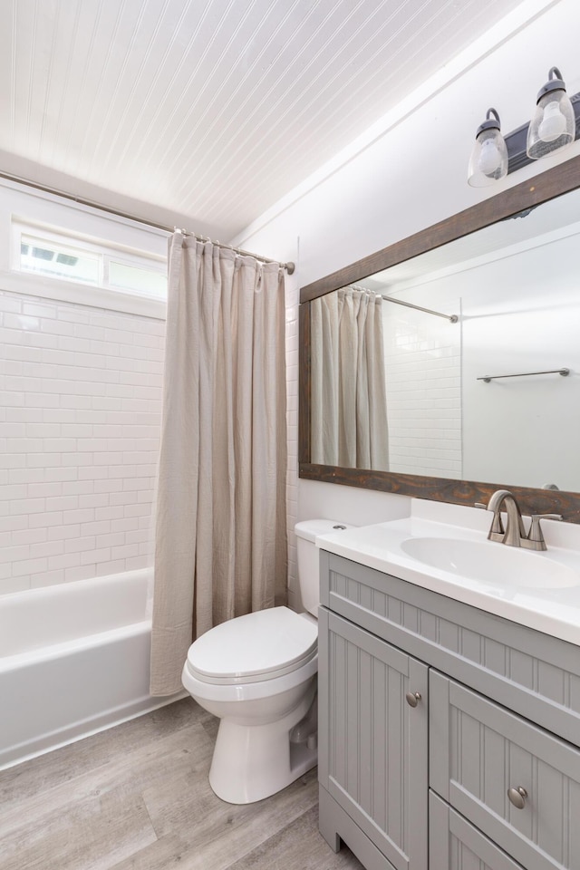 full bathroom with shower / bath combination with curtain, toilet, vanity, and wood-type flooring