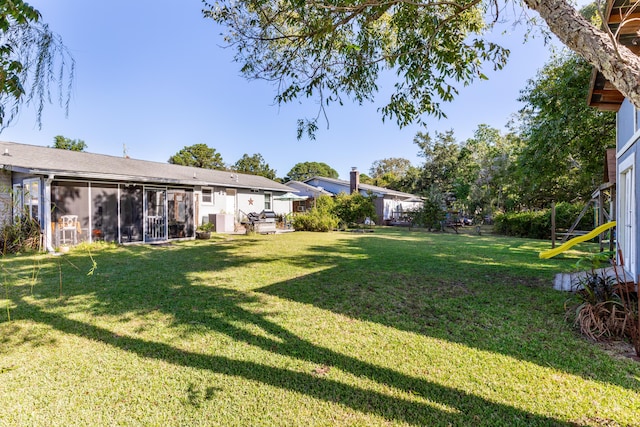 view of yard featuring a sunroom