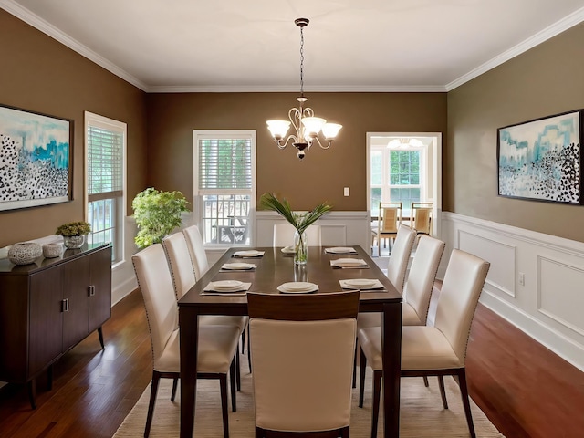 1514 Reevesville Rd, Bowman, SC 29018 - dining area featuring a chandelier, dark wood finished floors, crown molding, a wainscoted wall, and a decorative wall