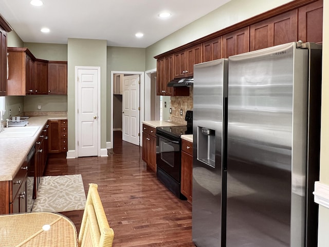 1514 Reevesville Rd, Bowman, SC 29018 - kitchen featuring stainless steel refrigerator with ice dispenser, black electric range oven, a sink, under cabinet range hood, and dark wood-type flooring