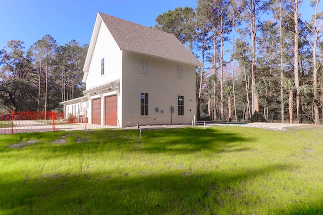 view of side of home with a garage and a yard