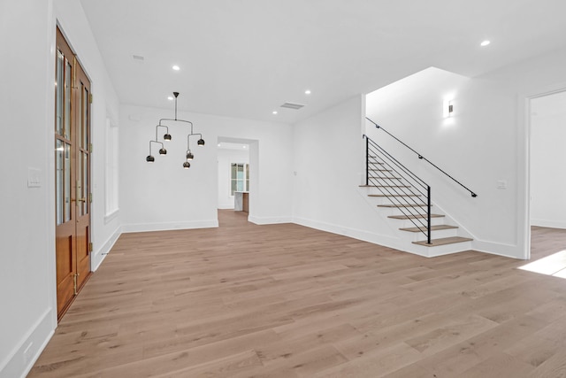 unfurnished living room with light hardwood / wood-style flooring