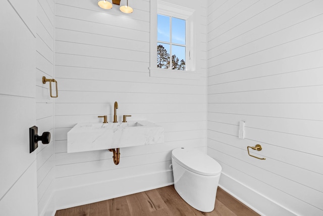 bathroom with hardwood / wood-style floors and toilet