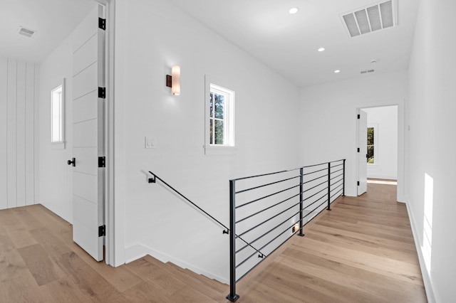 hallway featuring light hardwood / wood-style floors and a healthy amount of sunlight