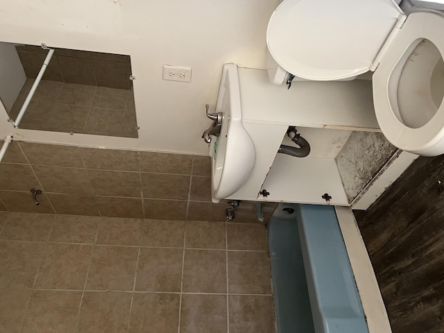 bathroom with toilet and tile patterned floors