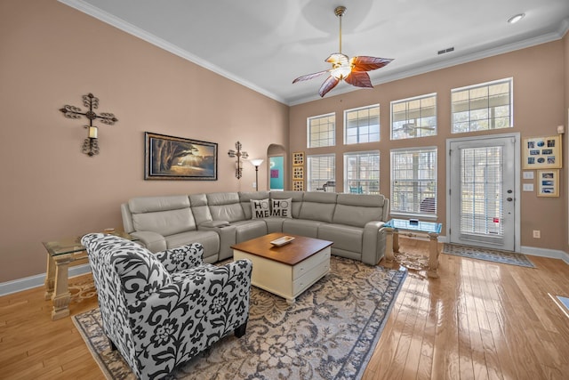 living area with a ceiling fan, light wood-style floors, and ornamental molding