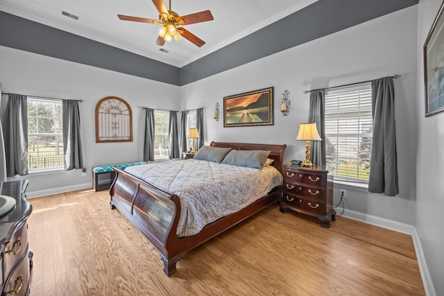 bedroom featuring baseboards, wood finished floors, a ceiling fan, and ornamental molding