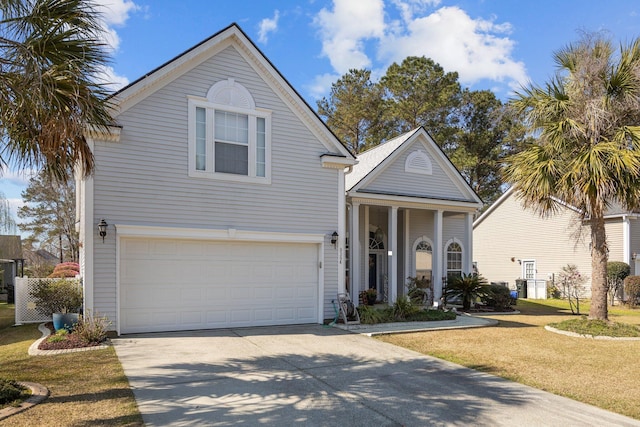 traditional-style home with driveway, an attached garage, and a front yard