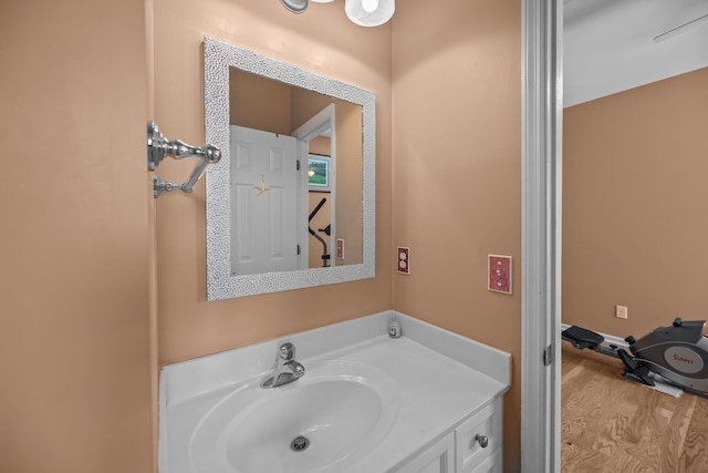 bathroom with wood finished floors and vanity