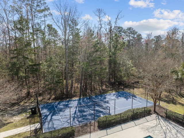 view of tennis court featuring fence