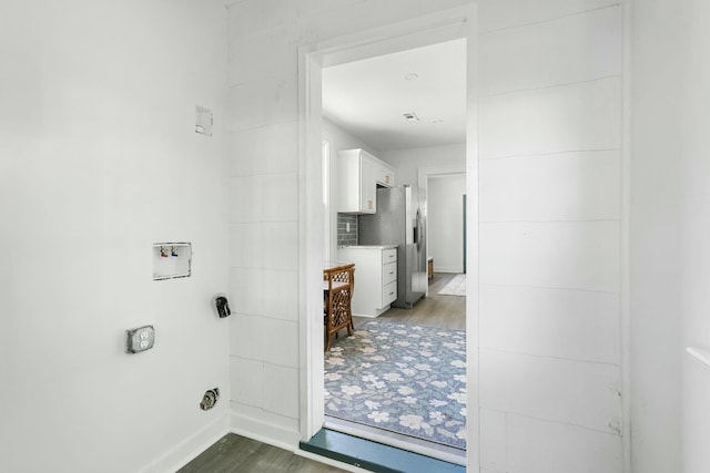 interior space featuring baseboards and wood finished floors
