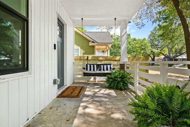 view of patio with a porch and fence