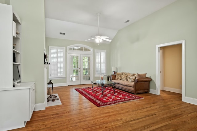 living room with visible vents, baseboards, a ceiling fan, and wood finished floors