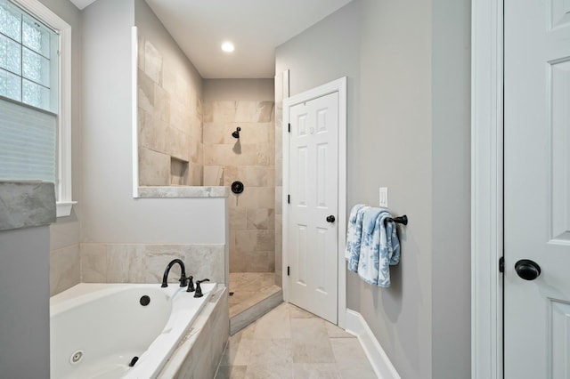full bath featuring a tile shower, a garden tub, marble finish floor, and baseboards