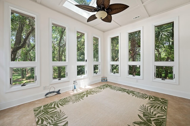 unfurnished sunroom featuring visible vents, tile patterned flooring, and a healthy amount of sunlight