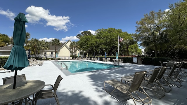 pool featuring a patio area and fence