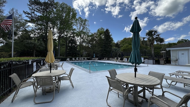 pool featuring a patio area and fence