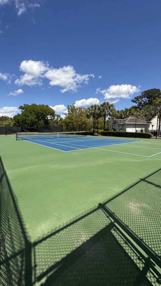 view of tennis court featuring fence