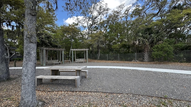 view of community with a pergola and fence