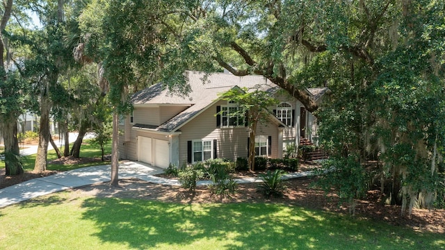 view of front of property featuring a shingled roof, a garage, stairs, a front lawn, and driveway