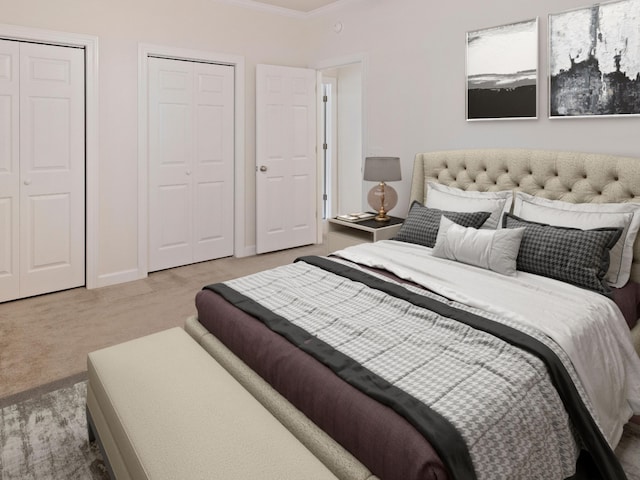 carpeted bedroom with two closets and crown molding