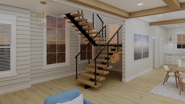 stairs featuring wood-type flooring, beamed ceiling, and a chandelier