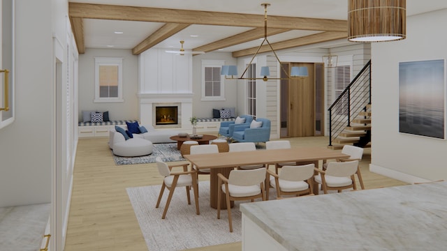 dining room featuring a fireplace, beamed ceiling, and light hardwood / wood-style flooring