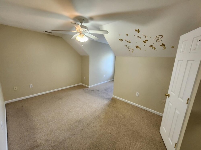 additional living space featuring light colored carpet, vaulted ceiling, and ceiling fan