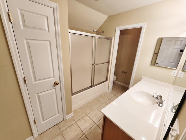 full bathroom featuring tile patterned flooring, combined bath / shower with glass door, vaulted ceiling, toilet, and vanity